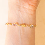 Bracciale vintage in oro giallo 18K con granati, ametiste, acquamarina, spinello blu sintetico e zaffiro bianco, anni ‘70
