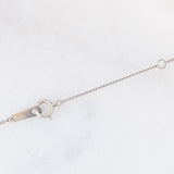 Collier vintage in platino con ciondolo a margherita con smeraldo (0.35ct) e diamanti (0.23ctw)