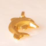 Collana con catenina in argento dorato e con tre ciondoli a forma di delfino in oro giallo 18K, di ancora in oro giallo 18K e di tartaruga in oro giallo 14K