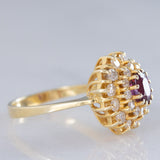 Anello a fiore vintage in oro giallo 14K con rubino (1ct ca.) e diamanti di taglio brillante (0.70ctw ca.), anni ‘70