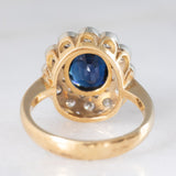 Anello a margherita vintage in oro 18K con zaffiro (1.10ct ca.) e diamanti di taglio brillante (0.50ctw ca.), anni ‘60