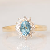 Anello a margherita vintage in oro giallo 9K con topazio azzurro (0.55ct ca.) e diamanti (0.05ctw ca.)