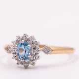 Anello a margherita vintage in oro giallo 9K con topazio azzurro (0.45ct ca.) e diamanti (0.14ctw ca.), anni ‘90