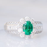 Anello a fiore vintage in platino con smeraldo (0.81ct) e diamanti (0.93ctw), anni ‘80
