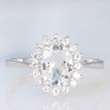 Anello a margherita in oro bianco 9K con acquamarina (1ct ca.) e diamanti di taglio brillante (0.16ctw ca.), anno 2006