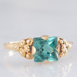 Anillo vintage de oro amarillo de 14 quilates con piedra verde y decoraciones florales y geométricas, años 50/60.