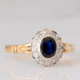 Anello a margherita vintage in oro giallo e bianco 9K con zaffiro (0.60ct ca.) e diamanti (0.12ctw ca.), anno 1991