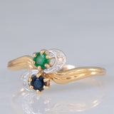 Toi et Moi vintage in oro giallo 18K con zaffiro (0.09ct ca.), smeraldo (0.06ct ca.) e diamanti, anni ‘70/‘80