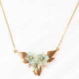 Vintage 9K yellow gold necklace with green glass paste in the shape of flowers, gold petals and white stones, 80s/90s