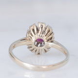 Anello a margherita vintage in oro bianco 14K con rubino (0.50ct ca.) e diamanti (0.30ctw ca.), anni ‘70/‘80