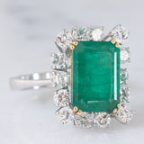 Anello a margherita vintage in oro bianco 14K con smeraldo (5.50ct ca.) e diamanti di taglio brillante (1.65ctw ca.), anni ‘70