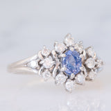 Anello a margherita vintage in platino con zaffiro (0.60ct) e diamanti (0.41ctw), anni ‘90