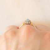 Anello a margherita vintage in oro giallo 9K con topazio azzurro (0.30ct ca.) e diamanti (0.06ctw ca.), anni ‘80