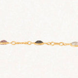 Bracciale vintage in oro giallo 18K con granati, ametiste, acquamarina, spinello blu sintetico e zaffiro bianco, anni ‘70