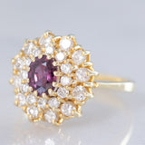 Anello a fiore vintage in oro giallo 14K con rubino (1ct ca.) e diamanti di taglio brillante (0.70ctw ca.), anni ‘70