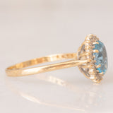 Anello a margherita vintage in oro giallo 9K con topazio azzurro (1.50ct ca.) e diamanti (0.10ctw ca.), anno 1988