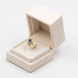Vintage 14k two-tone gold ring with central sapphire (0.60ct) and diamonds (0.16ctw), 80s