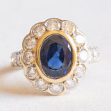 Vintage 14K yellow and white gold daisy ring with synthetic sapphire (approx. 2.50ct) and brilliant cut diamonds (approx. 1.80ctw), 80s