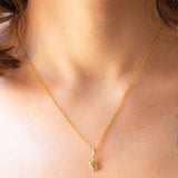 Collana con catenina in argento dorato e con tre ciondoli a forma di delfino in oro giallo 18K, di ancora in oro giallo 18K e di tartaruga in oro giallo 14K