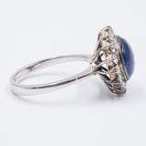 Vintage 18K gold ring with central cabochon sapphire and diamonds, 60s