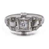 Art Decò ring in platinum with an old mine cut diamond (0,20 ct) and rosettes, 30s