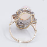 Двухцветное золотое кольцо 18 карат с опалом (4.60 карата) и бриллиантами круглой огранки (0.44 карата)