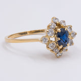 Vintage-Ring aus 18 Karat Gelbgold mit zentralem Saphir und Diamanten (0.50 ctw), 70er Jahre