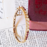 14K gold rigid bracelet with diamonds (1.40ctw approx.) And rubies (1.30ctw approx.), 50s
