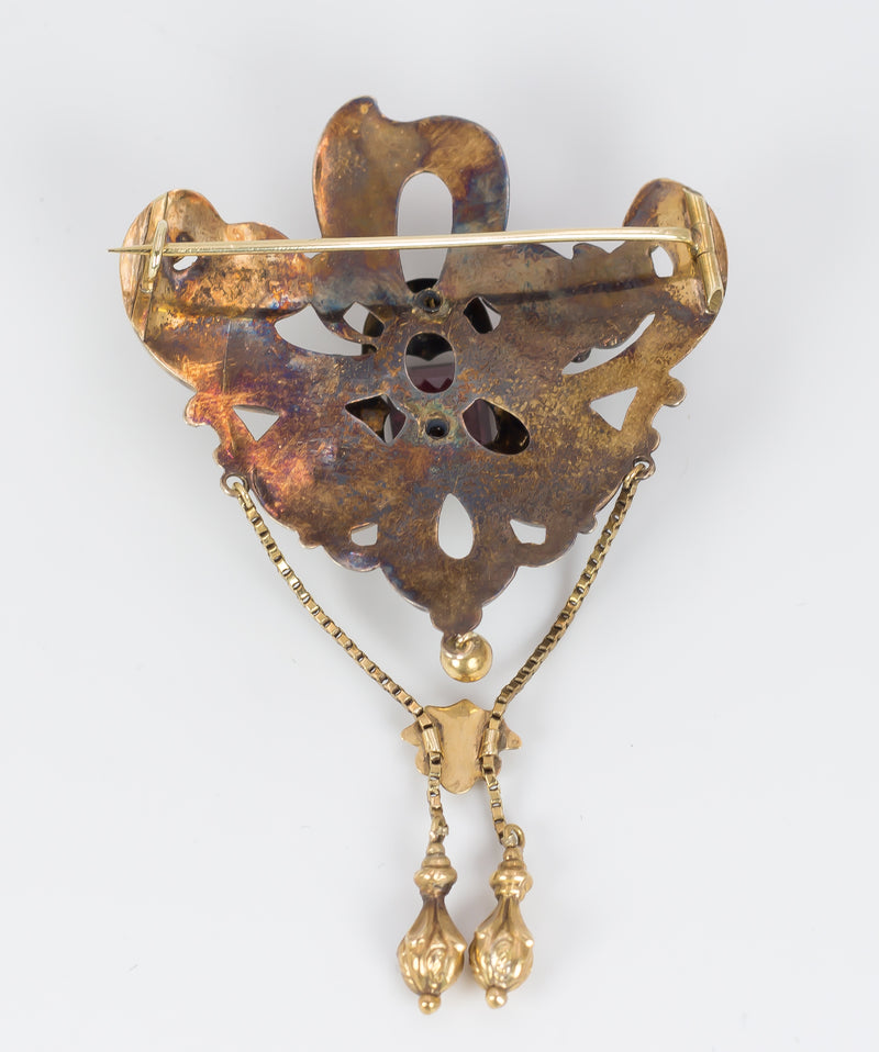 Antique gold brooch with enamels and garnet, second half of the 19th century.