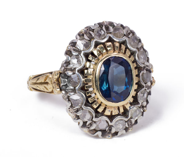 Anello vintage in oro e argento con zaffiro centrale e rosette di diamante, anni 40