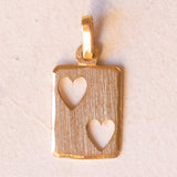 Lot including 18K gold pendant with zircon and pendant in the shape of a card of two of hearts in 18K gold